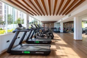 a row of treadmills in a gym with a row of exercise bikes at Sanset Waves with a sea view! in Benidorm