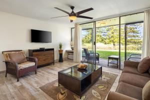 a living room with a couch and a tv at Tee and Sea Getaway ay Turtle Bay in Kahuku
