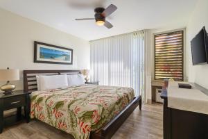 a bedroom with a bed and a ceiling fan at Tee and Sea Getaway ay Turtle Bay in Kahuku +36 photos