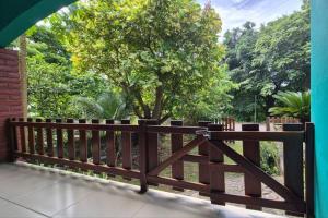 a wooden fence with a tree in the background at Casa Andrew - Cozy Island Home in Santa Cruz