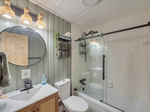 a bathroom with a toilet and a sink and a shower at Lookout Lodge in Beech Mountain +58 photos
