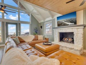 a living room with a couch and a fireplace at Lookout Lodge in Beech Mountain
