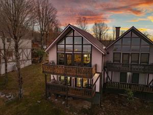 a house with large windows and a balcony at Lookout Lodge in Beech Mountain