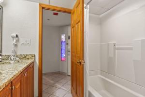 a bathroom with a tub and a sink and a shower at Beach Cove Resort - Oceanfront Condo - Unit 1516 in Myrtle Beach +43 photos