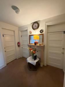 a room with two doors and a clock on the wall at Pleasant Rooming House in Washington, D.C.