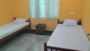 Un pat sau paturi într-o cameră la Charis Villa in Kunnamkulam near Guruvayoor