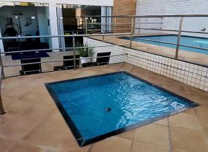 a large swimming pool on the top of a building at Flat Biarritz - Praia Litorânea in São Luís
