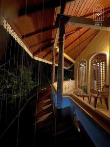 a porch of a house with a table and chairs at Villas by DIMA in Galle