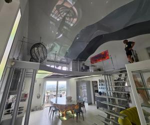 a dining room with a table and a ceiling with skylights at Villa Paradiso by Monarca Prestige in Furiani