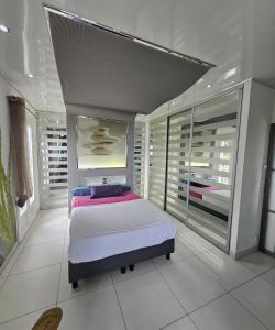 a bedroom with a bed and a large window at Villa Paradiso by Monarca Prestige in Furiani +37 photos