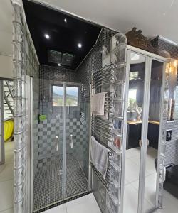 a bathroom with a shower with a glass door at Villa Paradiso by Monarca Prestige in Furiani