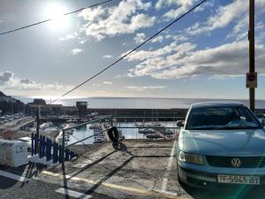 a car parked in a parking lot next to a marina at Apartamento Puerto Estaca 1 in Valverde +29 photos