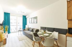 una sala de estar con un sofá y una mesa en SkyTravel 26 Apartament Pileckiego Nowy Dwór Mazowiecki Airport Modlin 24H, en Nowy Dwór Mazowiecki