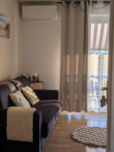 salon z kanapą i oknem w obiekcie Studio décoration fêtes Noël et fin année vue mer plage aéroport Nice centre commercial CAP 3000 Arenas emplacement excellent w mieście Saint-Laurent-du-Var