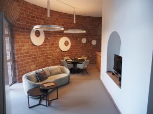 a living room with a couch and a brick wall at Ein Traum im Turm, historischer Wasserturm Worms in Worms