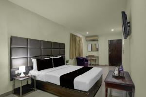 Ένα ή περισσότερα κρεβάτια σε δωμάτιο στο Hotel O Swagath Inn