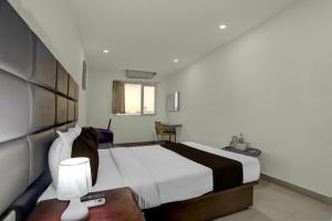 Ένα ή περισσότερα κρεβάτια σε δωμάτιο στο Hotel O Swagath Inn