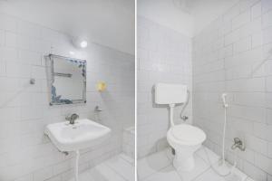 Hotel O Buddha Statue Gaya Formerly Uruvela International في بود جايا: حمام أبيض مع مرحاض ومغسلة