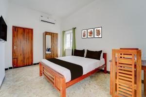 Voodi või voodid majutusasutuse Hotel O Muthalipalayam Bus Stand Coimbatore Formerly Haven Stays toas