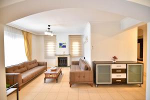 a living room with a couch and a table at Villa Rosetta in Cedit