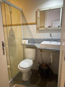 a bathroom with a toilet and a sink at Pousada Caponga Praia Mar in Cascavel