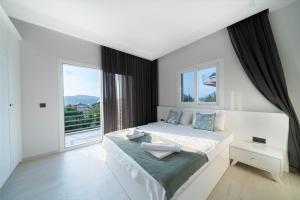 a bedroom with a large bed and a large window at Villa Riva in Oludeniz +28 photos