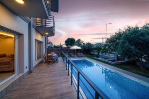 a house with a swimming pool on a balcony at Villa Riva in Oludeniz