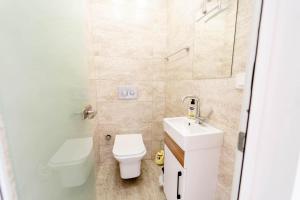 a small bathroom with a toilet and a sink at Villa Everest in Dalaman