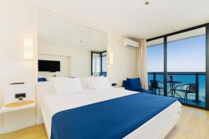 a bedroom with a large bed and a balcony at PANORAMA view premium class rooms in Batumi +47 photos