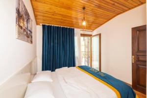 a bedroom with a bed with a blue curtain at Taksim full House in Istanbul