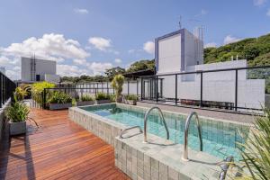 a swimming pool on the roof of a building at Aurea Cabo Branco Beach in João Pessoa
