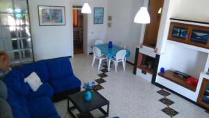 a living room with a blue couch and a table at La Dimora di Patty in San Cataldo