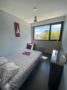 a bedroom with a bed and a large window at Mimosette Villa pool & jacuzzi 4 bedrooms in Le Pouliguen