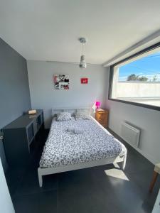 a small bedroom with a bed and a window at Mimosette Villa pool & jacuzzi 4 bedrooms in Le Pouliguen