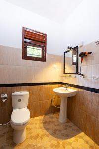 a bathroom with a toilet and a sink at Lira Unawatuna in Unawatuna +16 photos