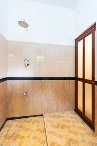 an empty room with a shower with a glass door at Lira Unawatuna in Unawatuna