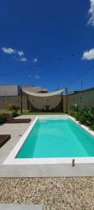 a swimming pool in front of a building at Hospedagem Moderna em Container in Foz do Iguaçu
