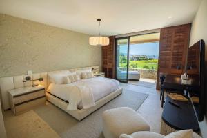 a bedroom with a bed and a desk and a piano at Ocean view Escape Private Plunge Pool Concierge in Punta Mita