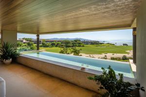 a swimming pool in a house with a large window at Ocean view Escape Private Plunge Pool Concierge in Punta Mita