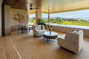 a living room with a table and chairs and a large window at Ocean view Escape Private Plunge Pool Concierge in Punta Mita +33 photos