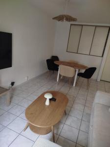 a living room with two tables and a couch at Appartement cocooning in Laval +5 photos