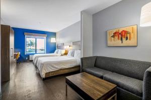 a hotel room with a bed and a couch at Holiday Inn Express & Suites Jacksonville - Atlantic Beach by IHG in Jacksonville +50 photos