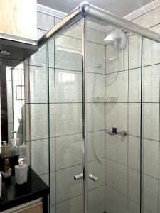 a shower with a glass door in a bathroom at Apartamento completo no centro da cidade in Passo Fundo