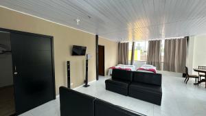 a living room with a couch and a table at Pousada Canto da Montanha in Guarujá