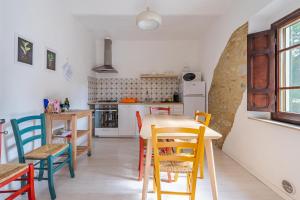 eine Küche und ein Esszimmer mit Tisch und Stühlen in der Unterkunft Molino Del Prato - Volterra in Ulignano