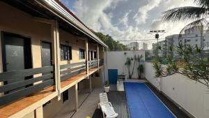 a balcony of a house with a swimming pool at Pousada Canto da Montanha in Guarujá
