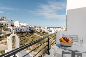 a bowl of fruit on a table on a balcony at Pnoe Luxe Apartment & Spa, Naxos Town in Naxos Chora