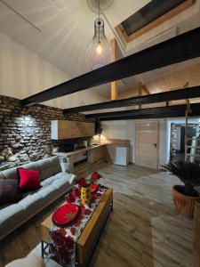 a living room with a couch and a table at Apartament nad belkami in Piece