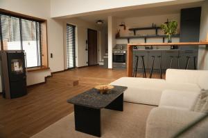 a living room with a white couch and a table at Cevizdibi Loft Villa in Kartepe