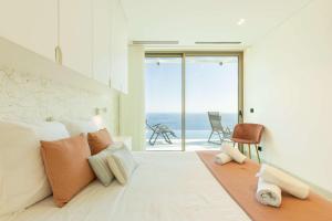 ein Schlafzimmer mit einem Bett und Meerblick in der Unterkunft Villa CLIFF HEAVEN HOUSE in Calheta + 33 Fotos